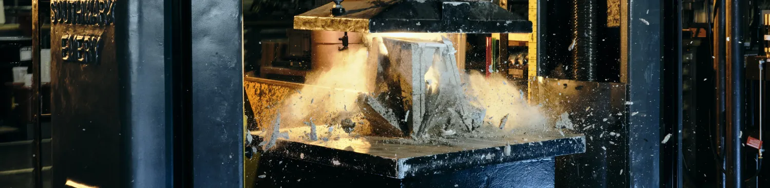 Southwark Emery 600k Universal Testing Machine breaking a concrete masonry unit.